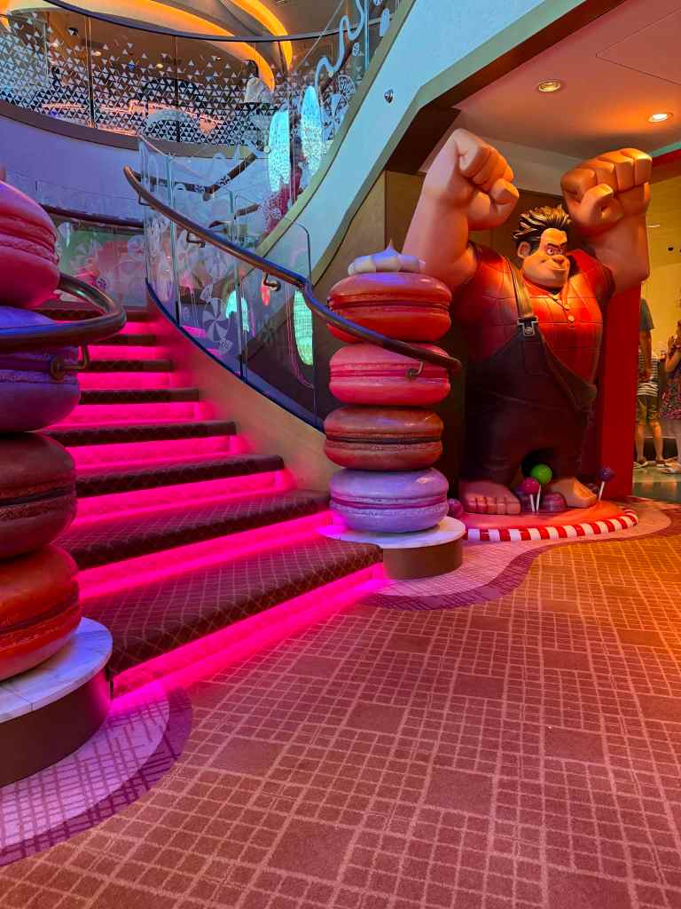Pink glowing staircase, with a giant Wreck-it-Ralph statue at the bottom. 